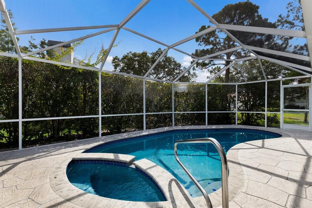 Privacy abound with the natural landscape around the pool plus a side-entry to the massive side yard.