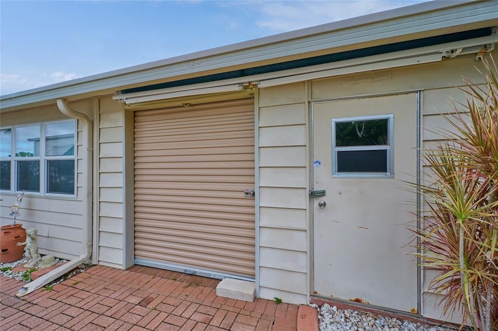 Roll-up door provides access to the utility room/shed