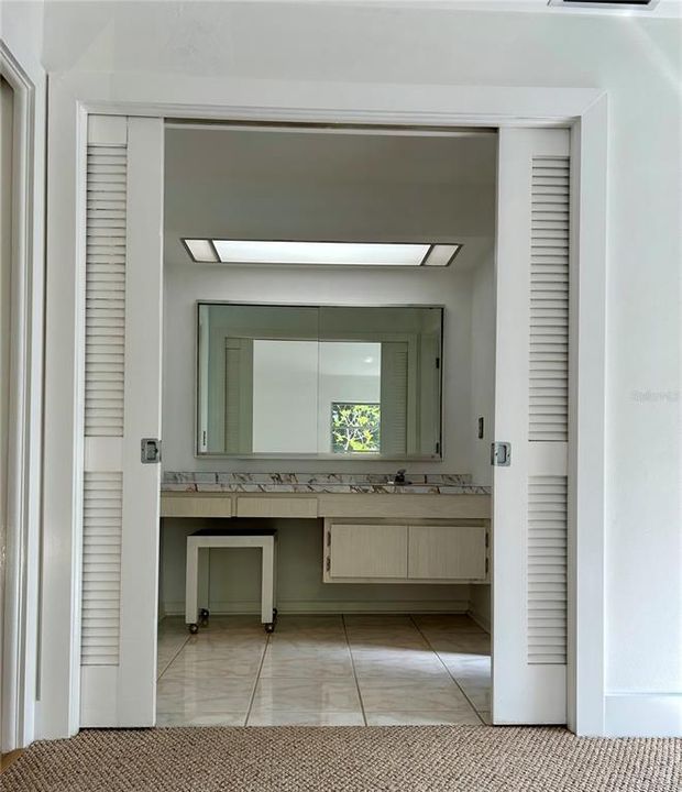 Blast from the past, this mid-century original vanity area offers plenty of space, light, and large mirror for "getting ready"