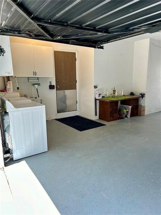 Laundry area is in garage, just outside the hall next to BR-2/Bath-2.