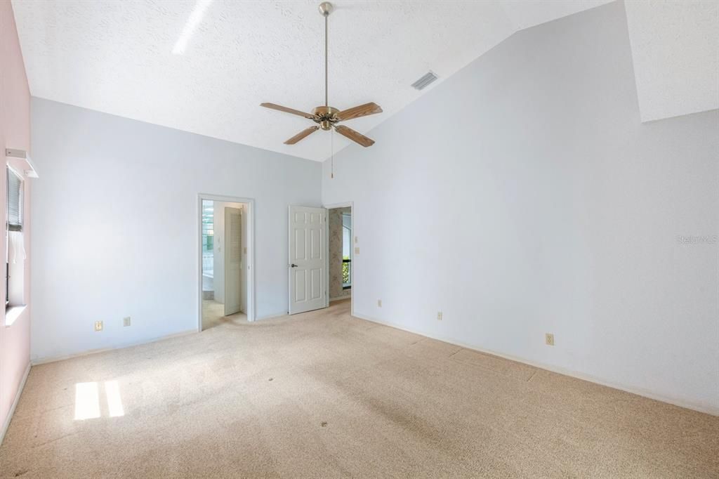 Primary bedroom has vaulted ceiling