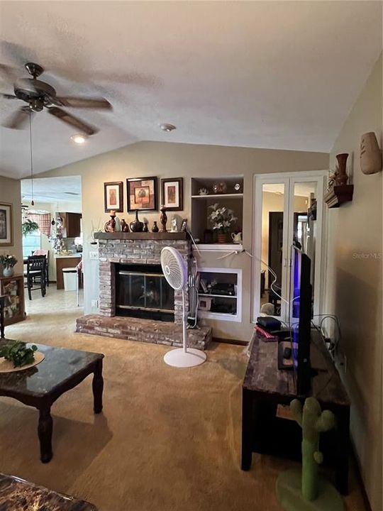 FAMILY ROOM WITH FIREPLACE AND BUILT IN SHELVES