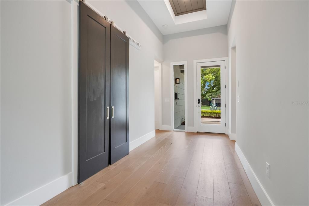 Open Foyer with sliding doors leading to first floor office space.