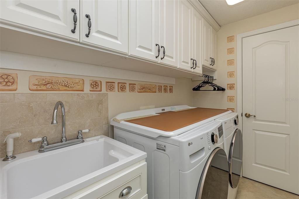 Spacious laundry room with storage closet