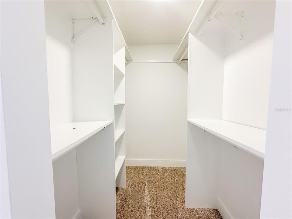 Primary Bedroom Walk In Closet with Built Ins