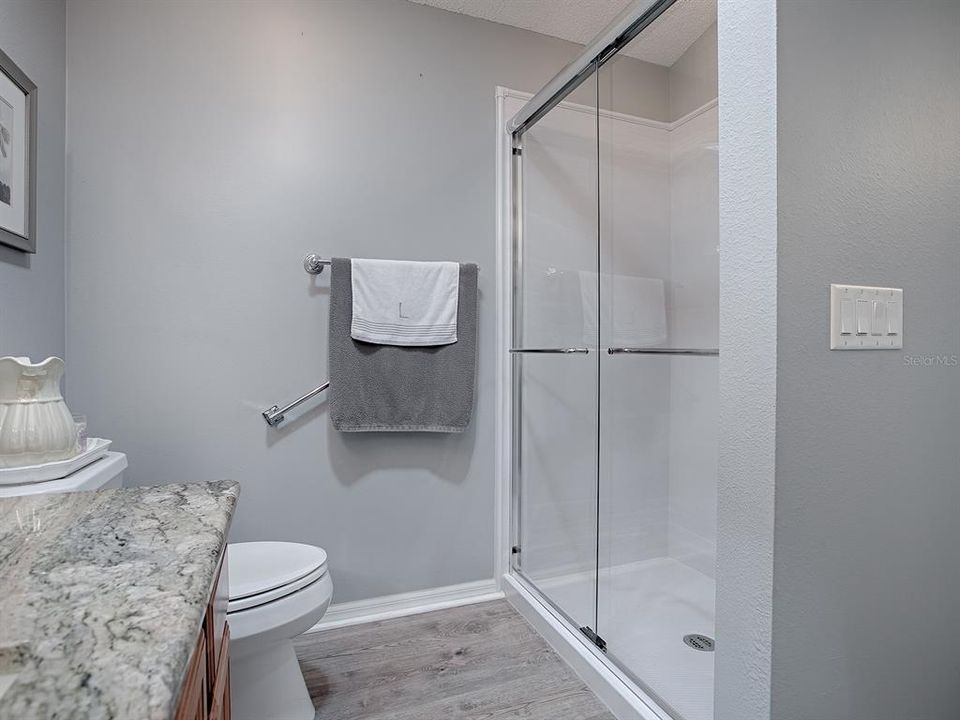 GLASS ENCLOSURE ON THE SHOWER.