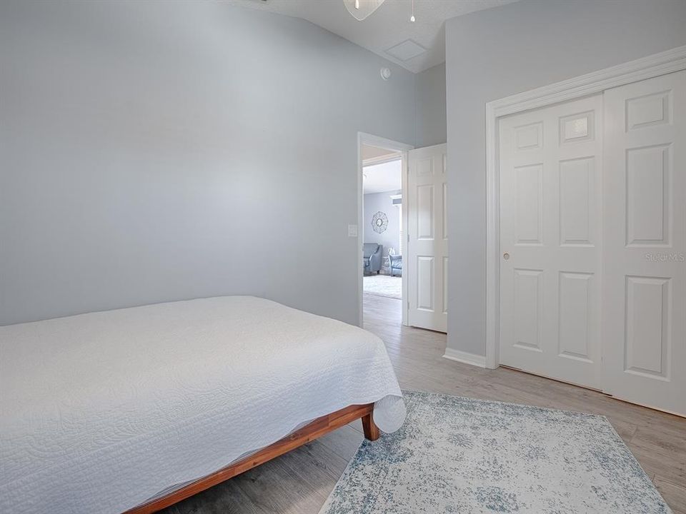 LARGE DOUBLE DOOR CLOSET WITH OVERHEAD LIGHTING.