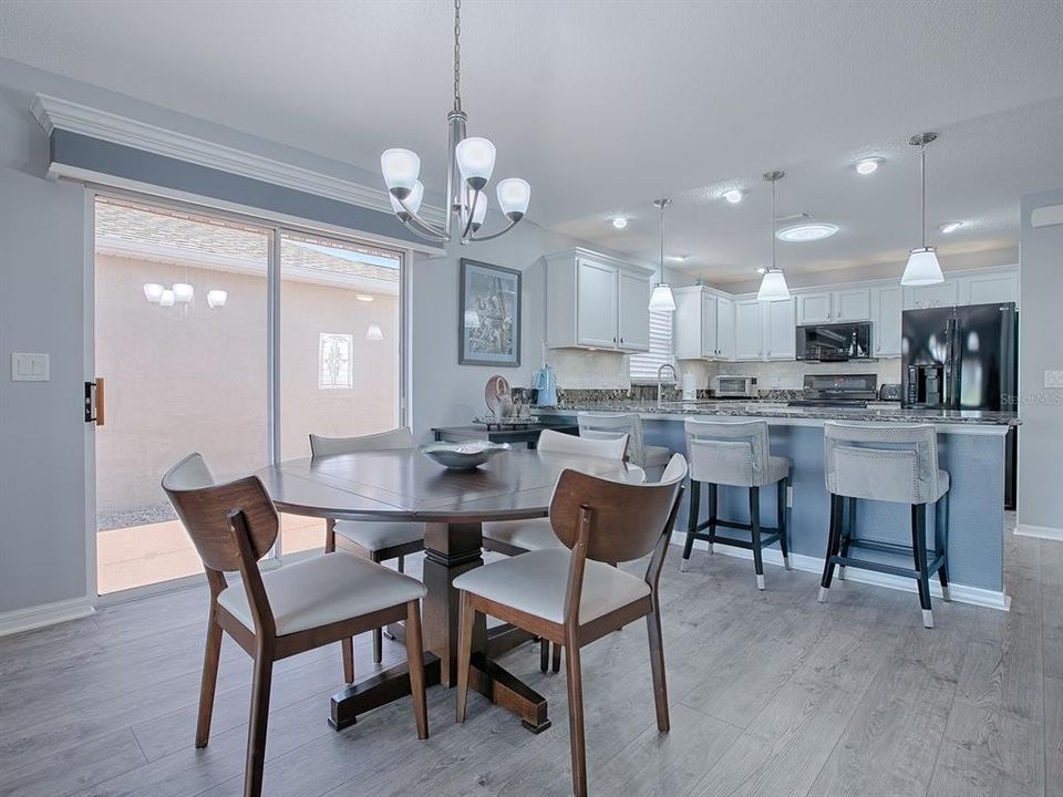 DINING ROOM HAS SLIDING GLASS DOORS WITH CUSTOM WOOD CORNICE WHICH OPENS OUT TO THE SIDE COURTYARD. THERE IS A REMOTE CONTROLLED AWNING OVER THE COURTYARD OFF THIS SLIDING GLASS DOOR.