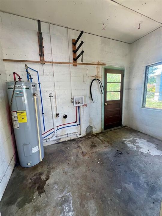 Laundry room under carport (shows entry from back yard)