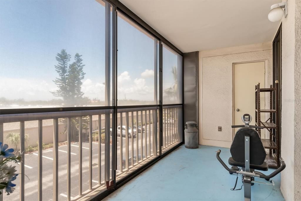 Screened balcony with storage closet at end.