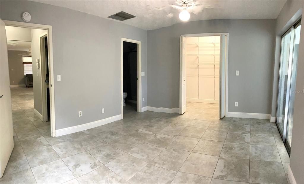 Large walk-in bedroom closet with adjustable shelving system.