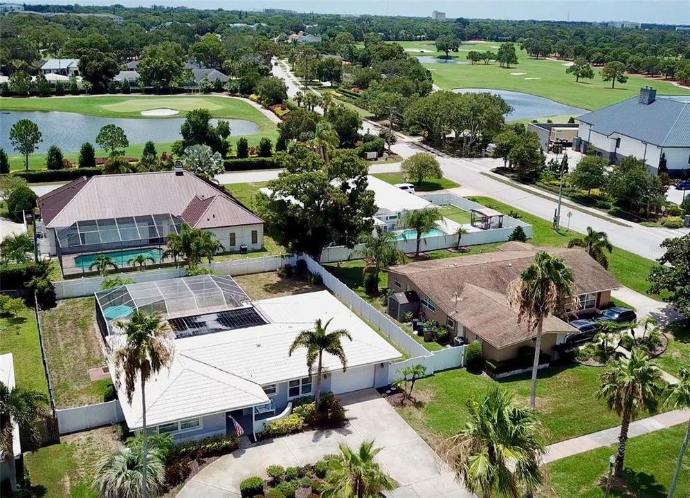 Large birdcage and entire yard fenced in.