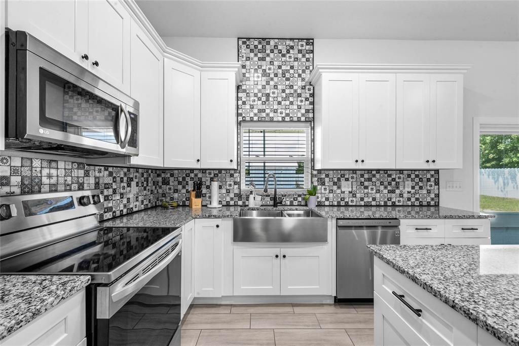 Kitchen - he kitchen design emphasizes a clean, modern aesthetic with ample storage and workspace. It includes essential appliances and fixtures for a fully functional kitchen.