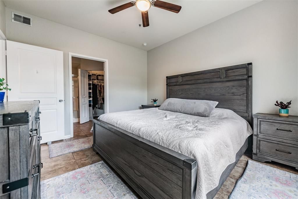 Master Bedroom, tile flooring and ceiling fan with light - all new paint throughout the condo.