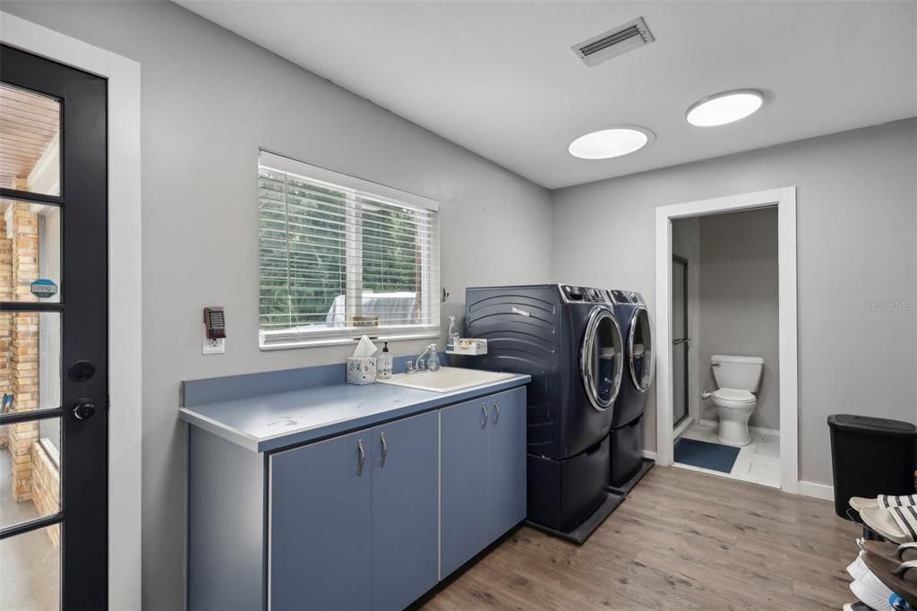 Large Utility room with full bath. Exterior door to the poll