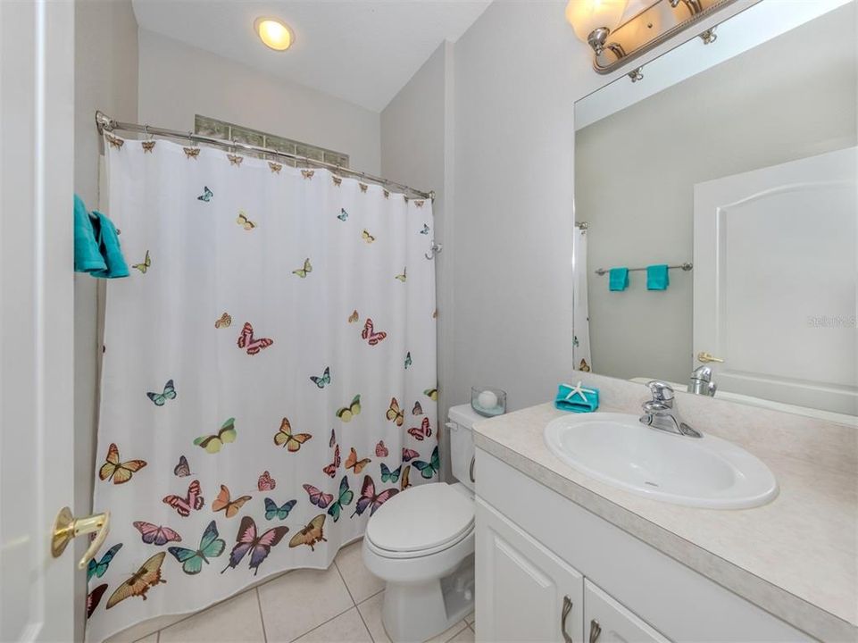 The guest bath is conveniently located near the second bedroom and doubles as a guest bath