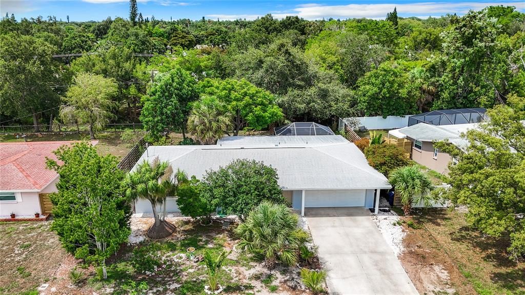 Mature landscaping surrounds the home