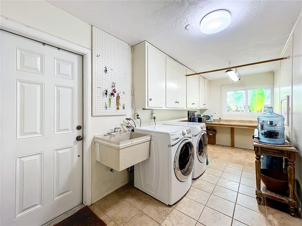 Indoor laundry room with utility sink