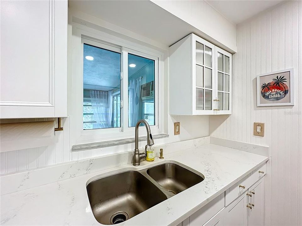 Window over the sink looks out onto the air conditioned lanai