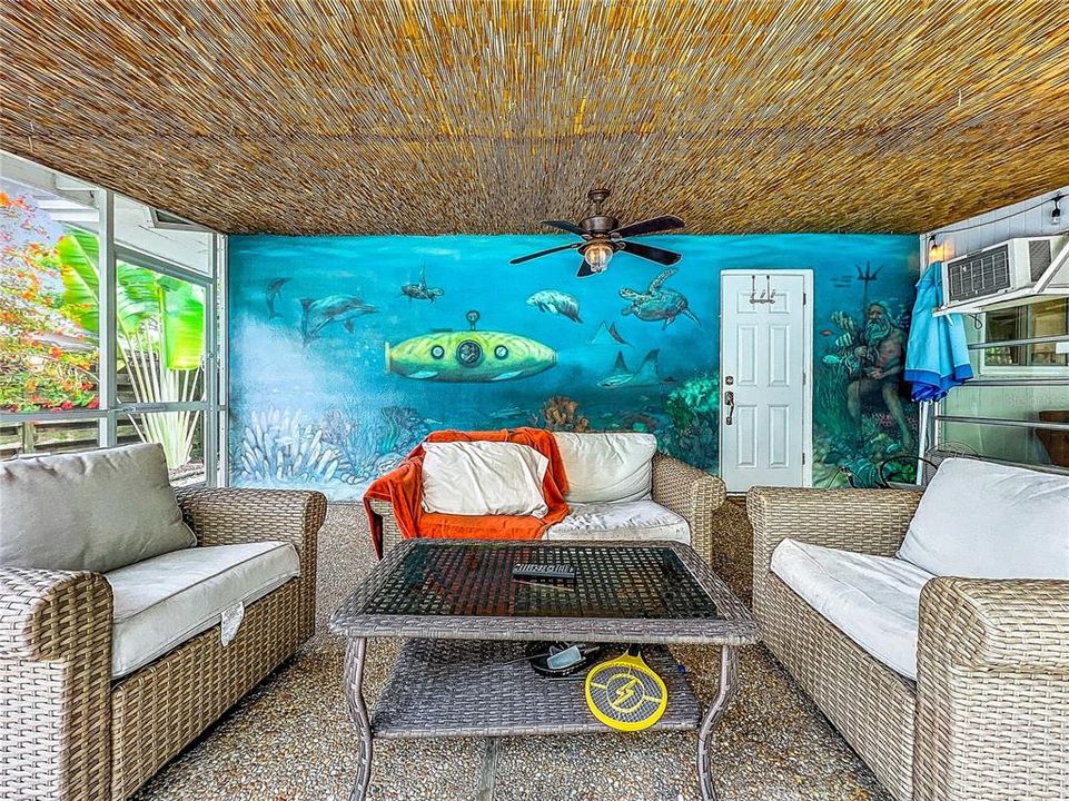 Custom wall mural adds a tropical vibe to the back patio