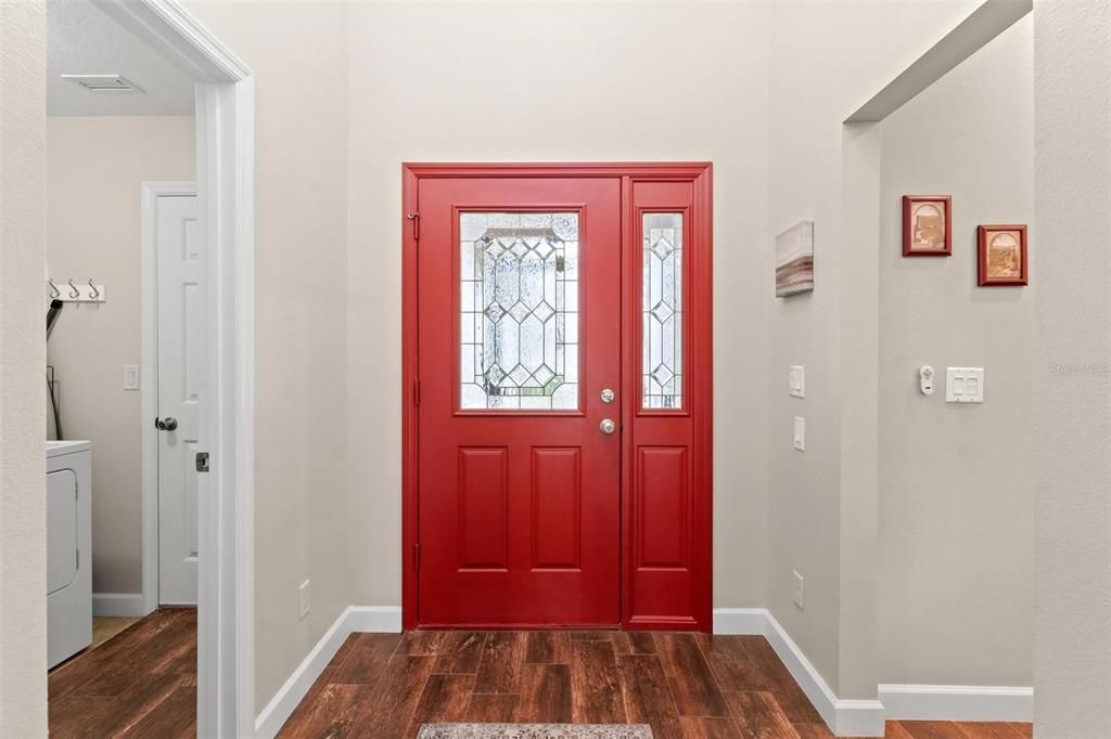 Foyer with laundry and garage to the left and kitchen on the right