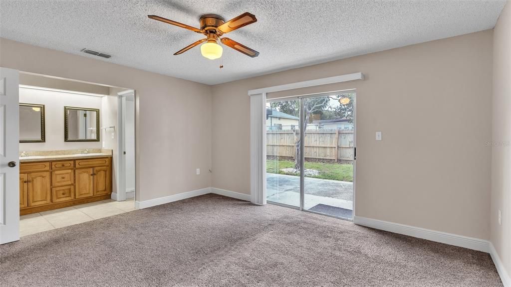 Primary Bedroom with Sliding Glass Doors to Open Patio