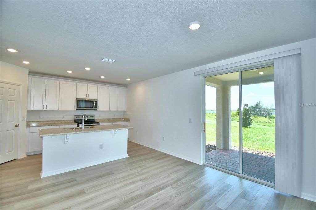 standing near foyer looking out into the covered lanai at Grassy Lake