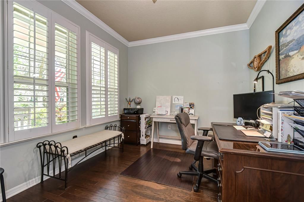 Enter the office through French doors and appreciate the wood floors and crown accents!