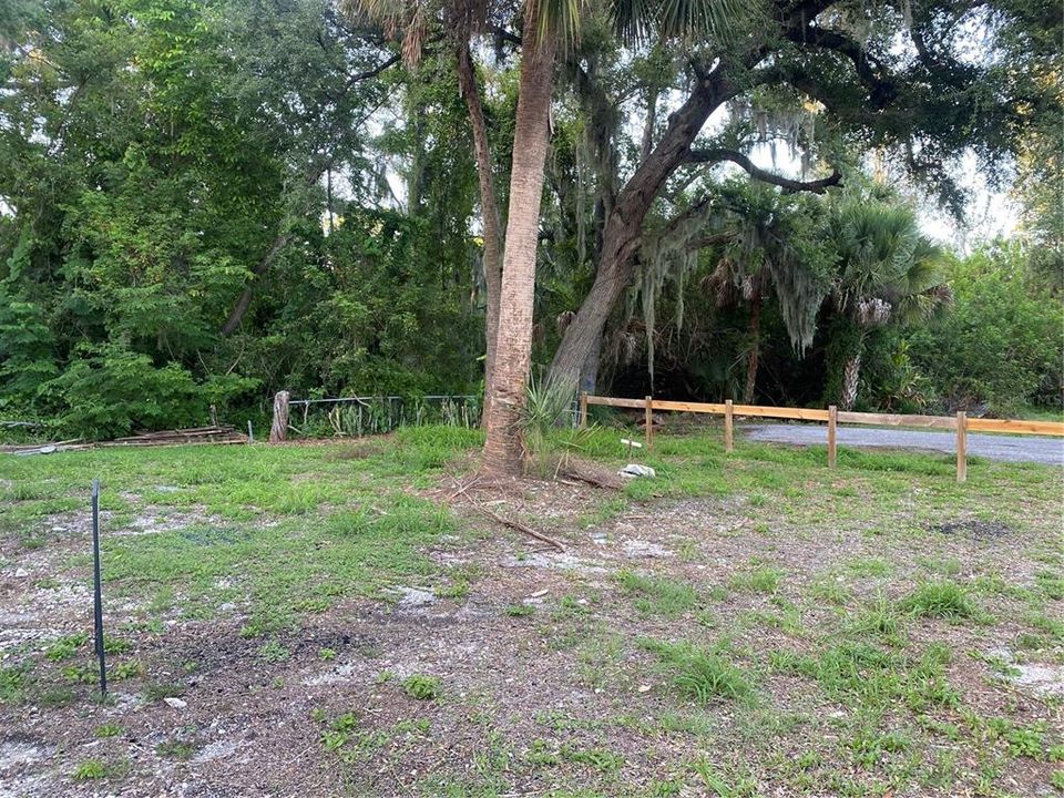 Lot view looking NE , removable wooden fence shows complete access from county paved road