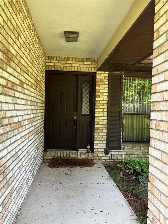 The front door is inviting and could be easily enclosed to allow the spring and fall breezes to flow through the home.