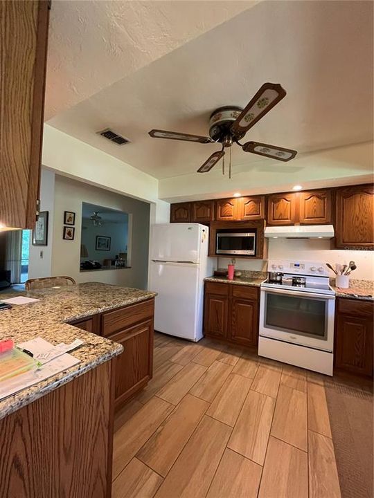 The kitchen has had updates to include flooring/granite countertops, under cabinet lighting and lighting above.  Large enough to enjoy cooking but not so big that you get lost.  Lots of cabinets.