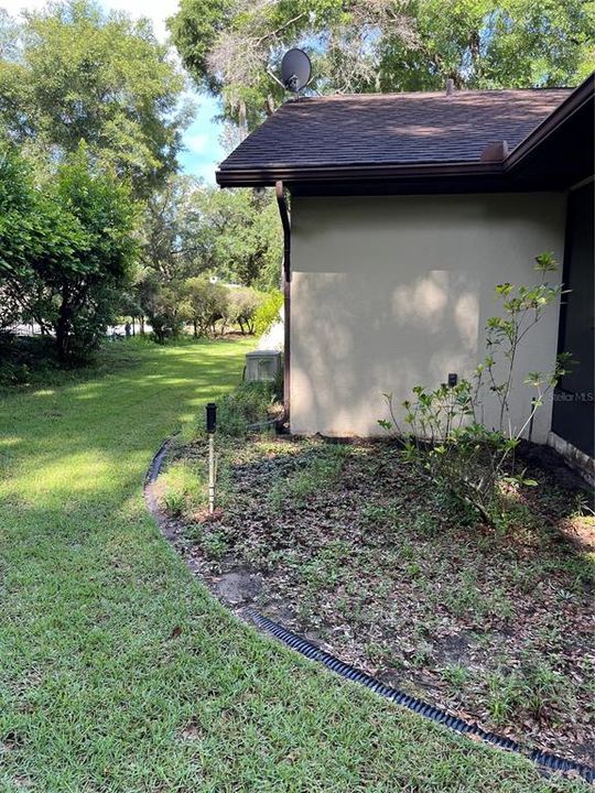 side yard next to Florida room looking back toward street