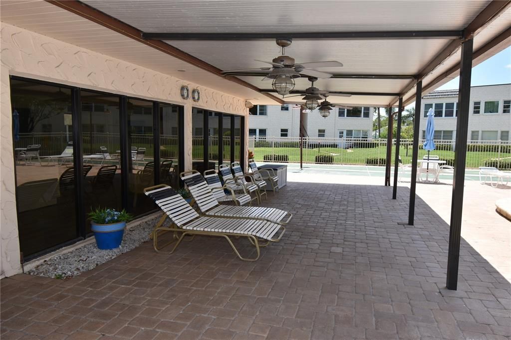 Covered pool seating next to clubhouse