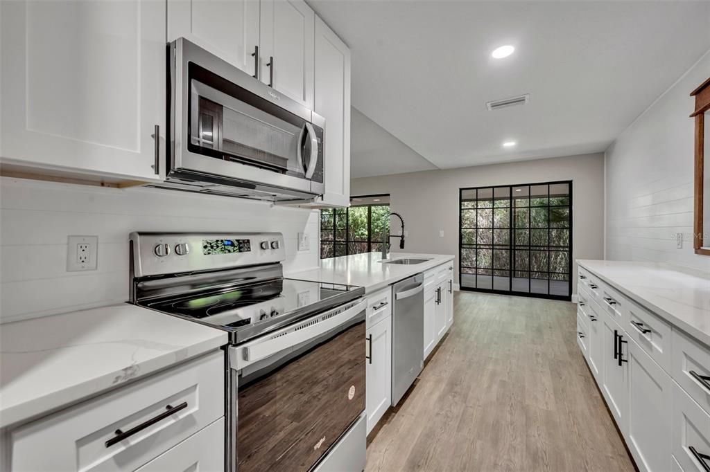 Kitchen area with view from Garage entrance door to dining and slider door.