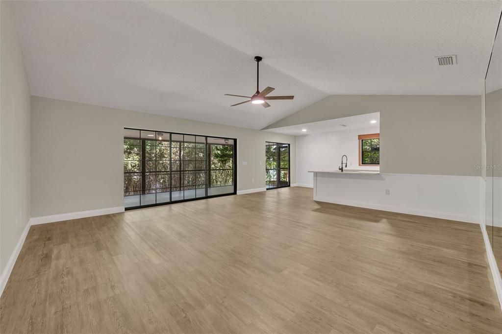 Living room with new LVP flooring that runs throughout the home.