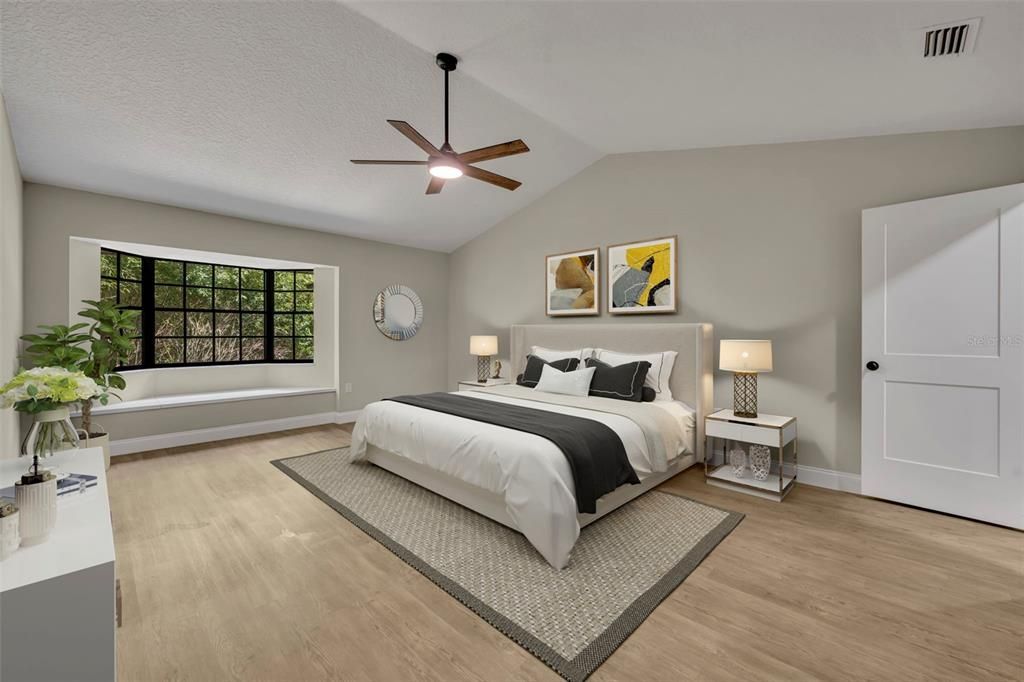 Master bedroom is spacious with vaulted ceilings, a nice window seat with lush views of the back and a spacious and modern bathroom with double vanity and walk-in closet.