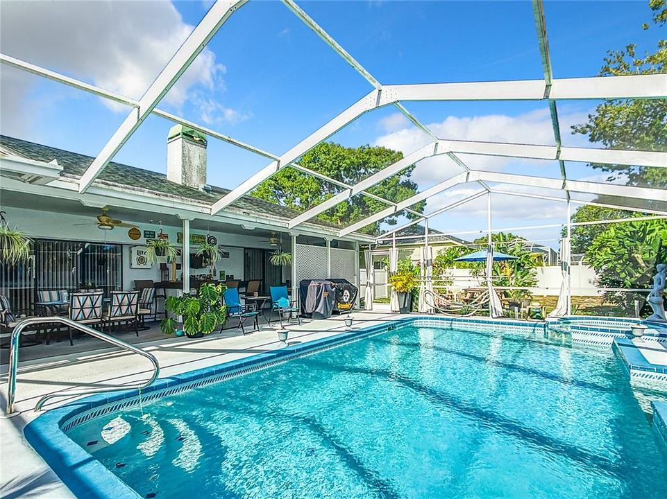 The caged in pool is 14'x28'. resurfaced in 2018 with a new pool pump and heater in 2019. The pool also has a jacuzzi area at the right rear of the picture. What a great place to spend a relaxing day.