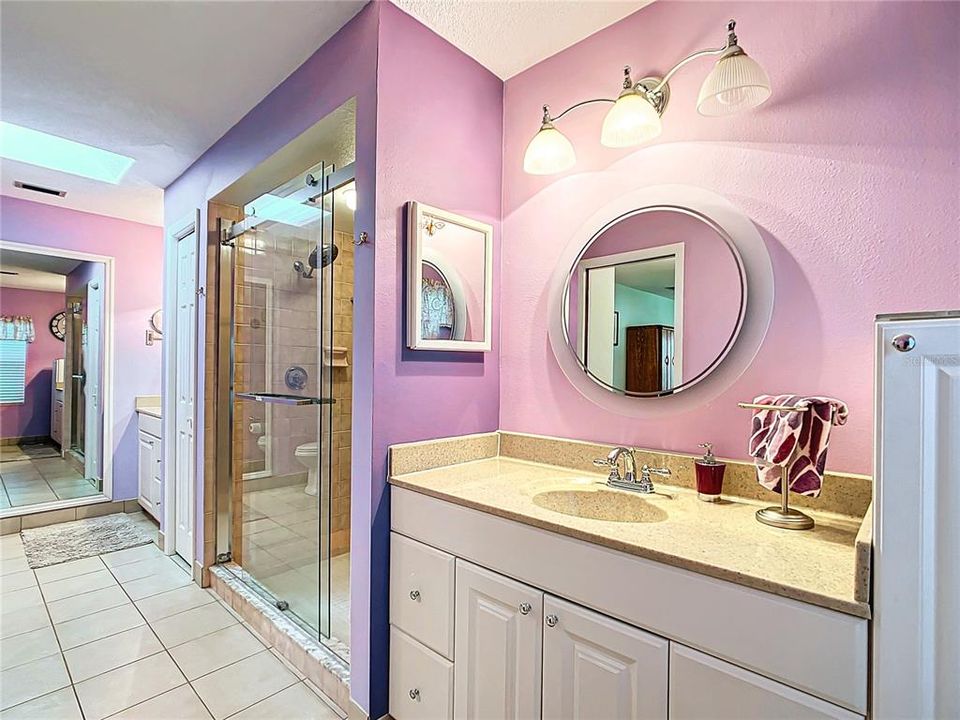 The master bedroom has separate vanities with sink. There is a separate enclosed shower and tub.