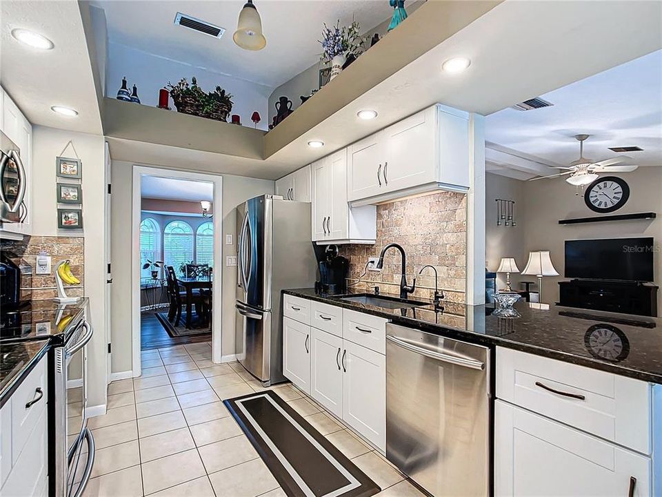 Stainless steel appliances accent the kitchen. A new farm style sink with motion faucet. Kitchen has adequate countertop space and also has a closet pantry for storage.