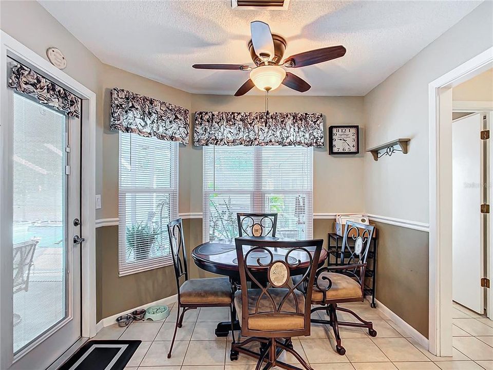 Dinette area in kitchen gives you a pool and back yard view through another bay window. There is also a door out to the pool area. Note: windows were replaced in 2018.