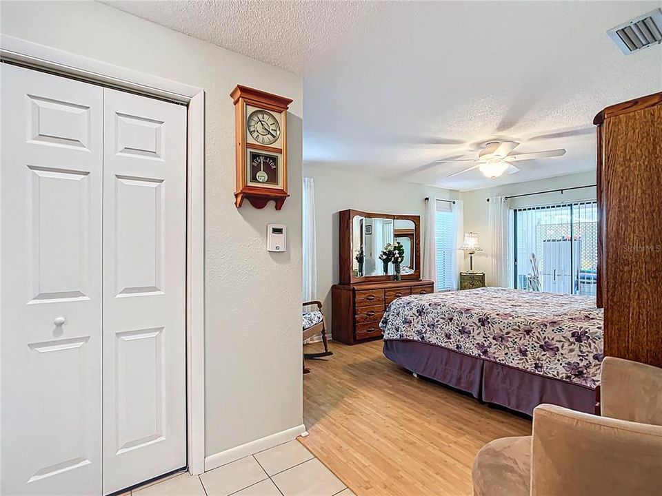 The master bedroom is separate from the other 2 bedrooms. Great size. Can accompany a king size bed and additional furniture with no problems. Newer ceiling fan. There is also a sliding glass door out to the pool area. The closet is a walk-in.