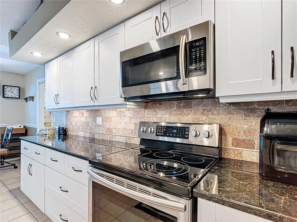 The kitchen was redone in 2021. Wood cabinets, solid surface counters, backsplash and recessed lighting all new.