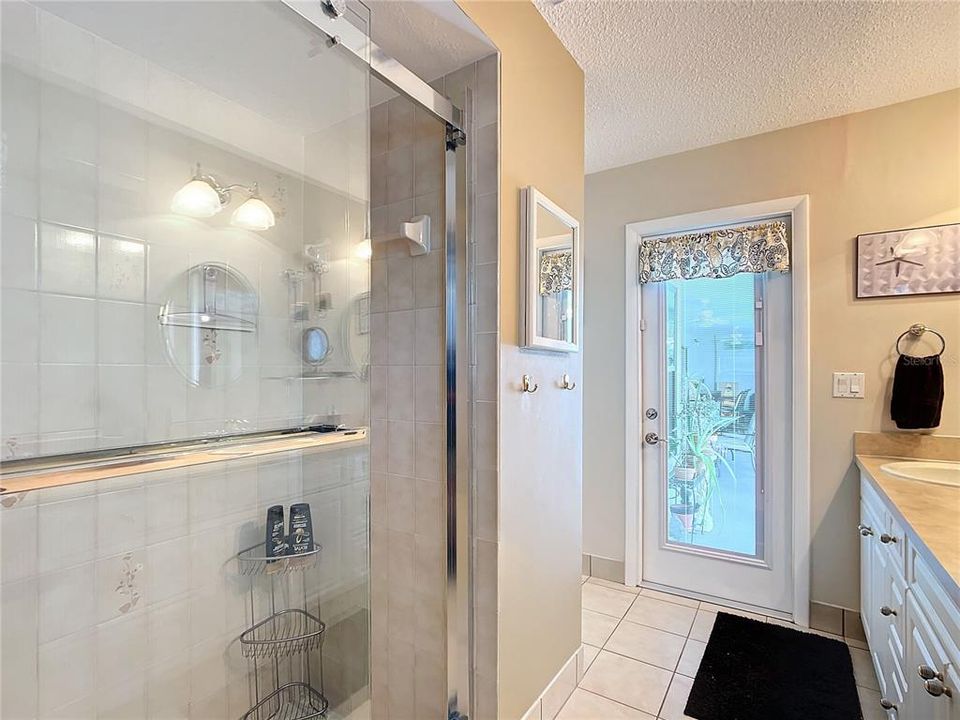 Bathroom 2 showing door out to the pool area.