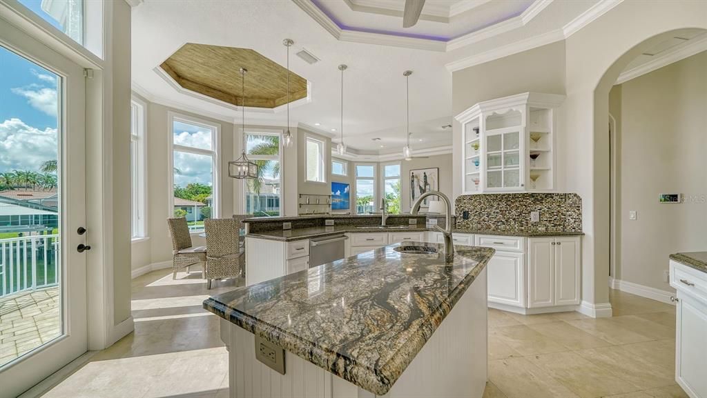 Kitchen overlooks breakfast nook and family room