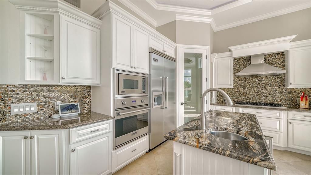 Another view of kitchen with built in oven, microwave, and cooktop