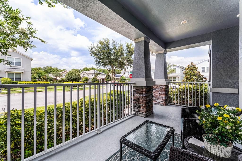 The front porch was upgraded from the original elevation for added curb appeal with the paver driveway and 2-car garage in the rear of the home.