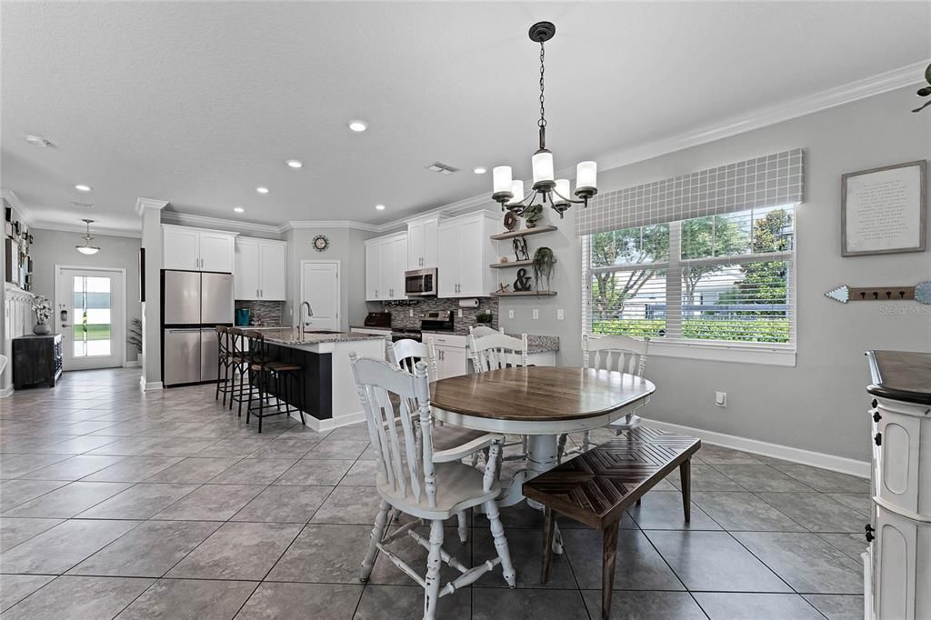 Chic TILE FLOORS set on a diagonal run throughout your main living areas starting in the foyer offering site lines straight through to covered lanai and fenced yard.