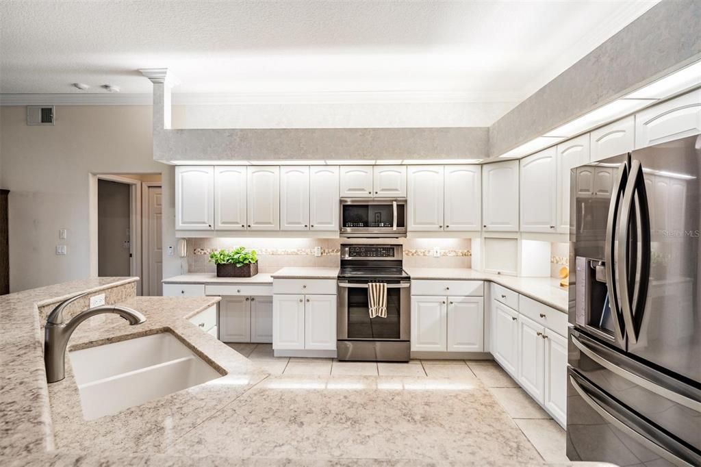 Crisp, white kitchen highlighted by all-stainless appliances
