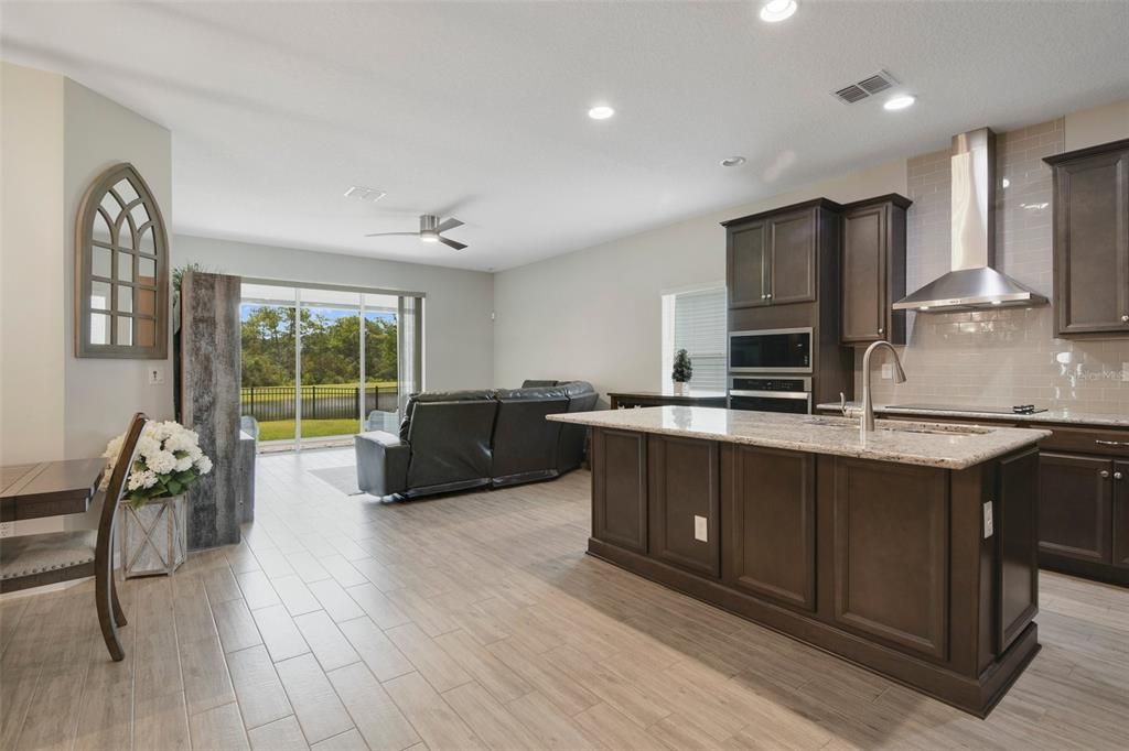 The WALK-IN PANTRY and built-ins off the dining area deliver ample storage, while TRIPLE SLIDING GLASS DOORS off the living area give you access to the lanai and the perfect water view!