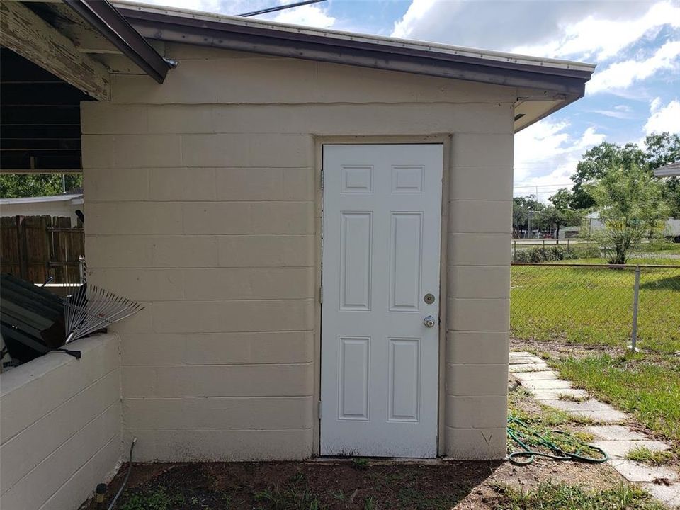 Laundry room attached to carport